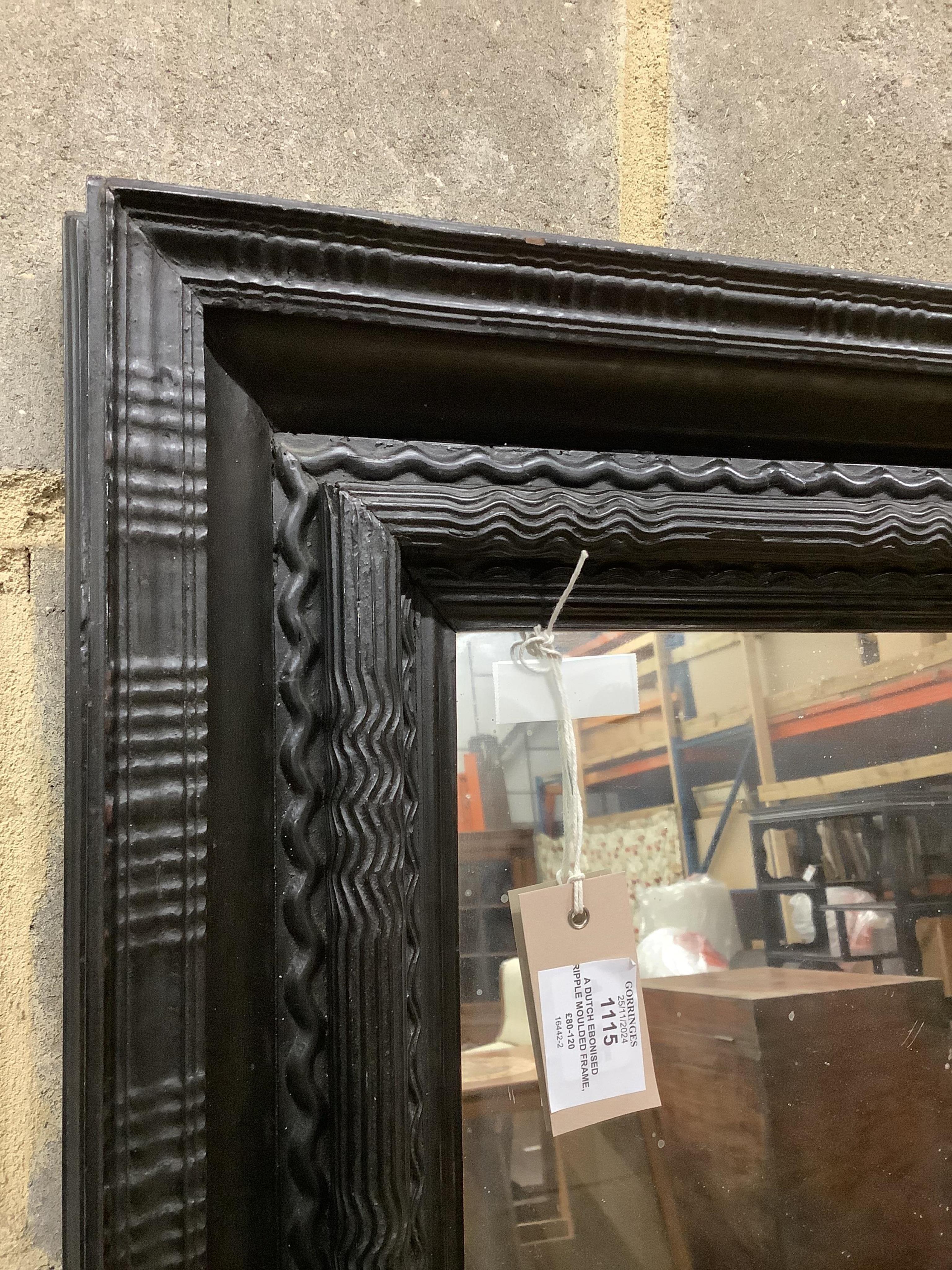 A Dutch ebonised ripple moulded frame, now a wall mirror, width 61cm, height 74cm. Condition - good